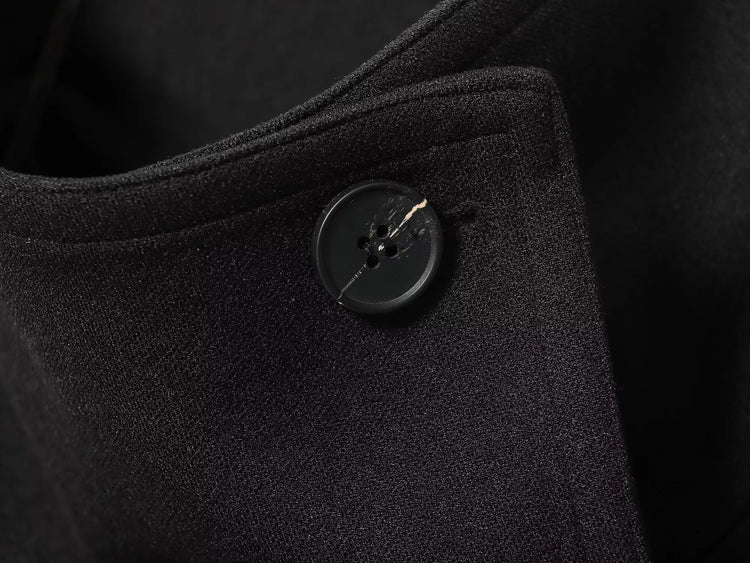 Black women's coat with buttons for Spring on a white background close up of button