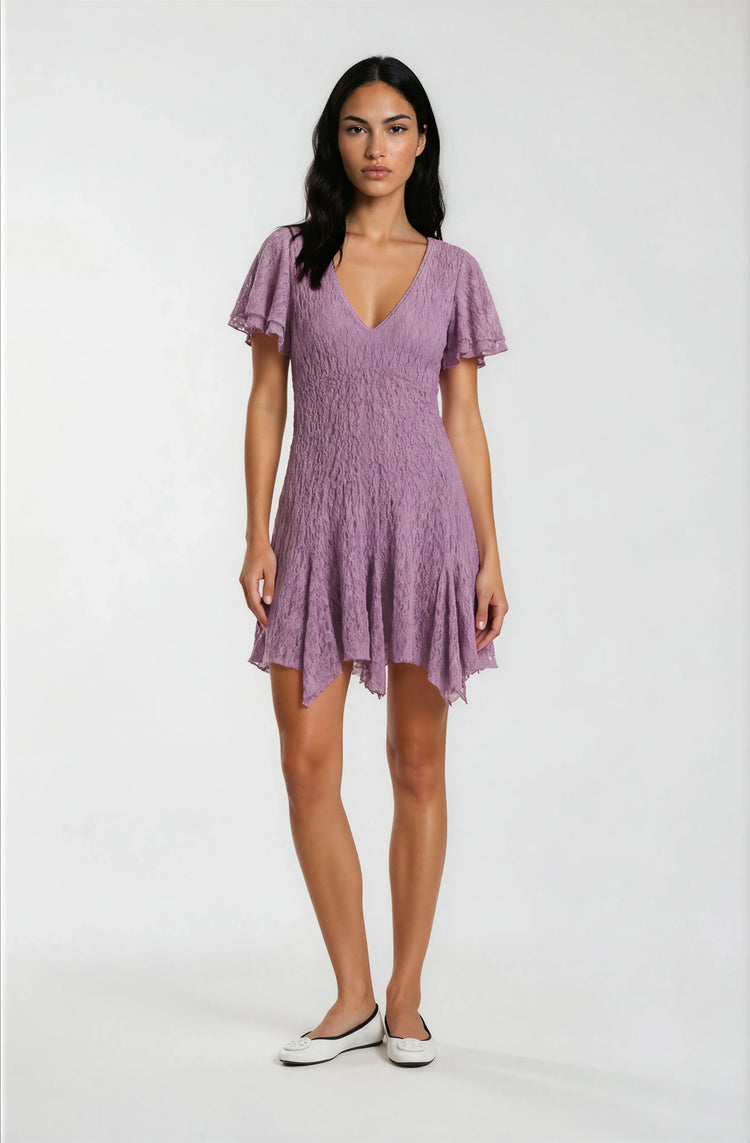 Woman wearing a purple dress on a white background
