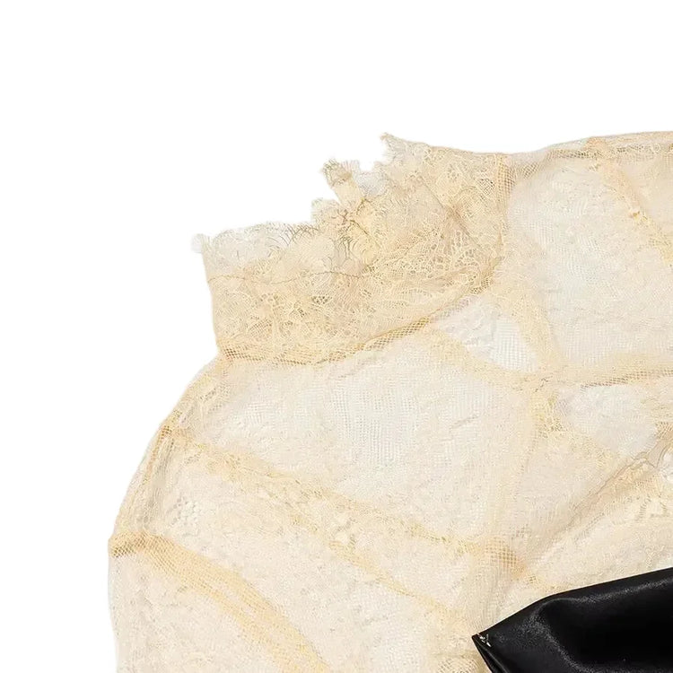 Close-up of a beige lace dress on a white background