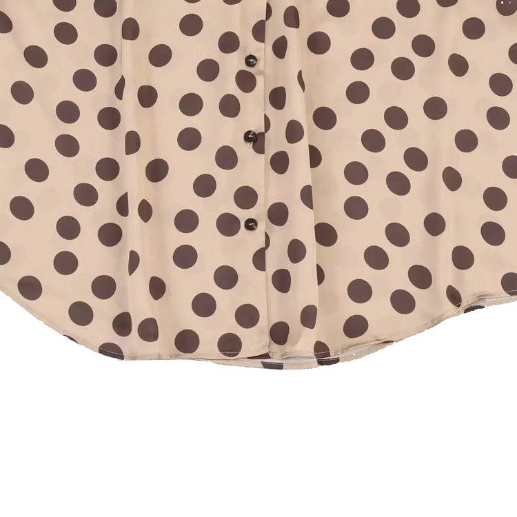 Beige shirt with brown polka dot pattern on a light blue background