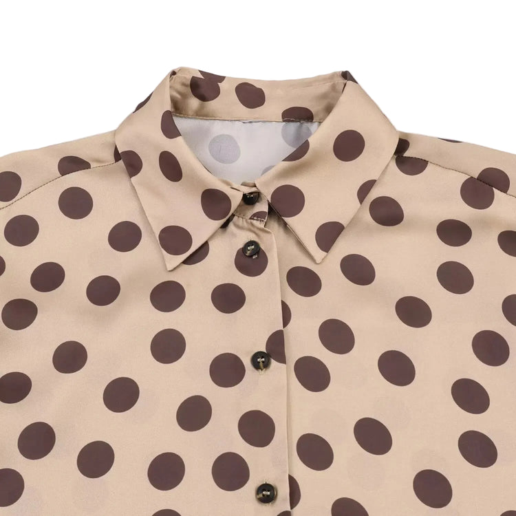 Beige shirt with brown polka dot pattern on a light gray background
