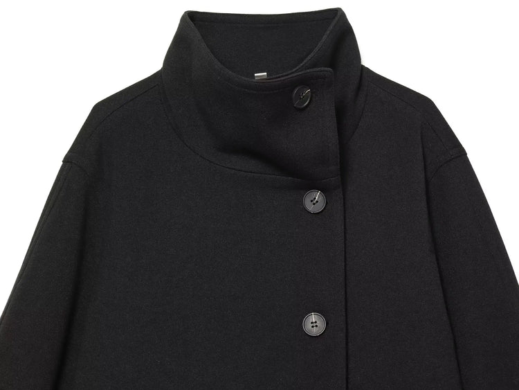 Black women's coat with buttons for Spring on a white background close up