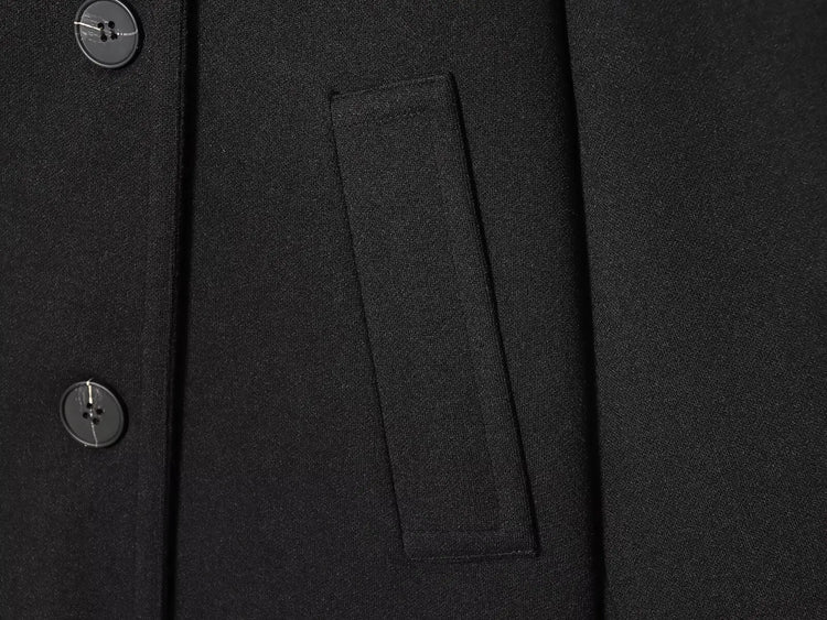 Black women's coat with buttons for Spring on a white background close up of pocket