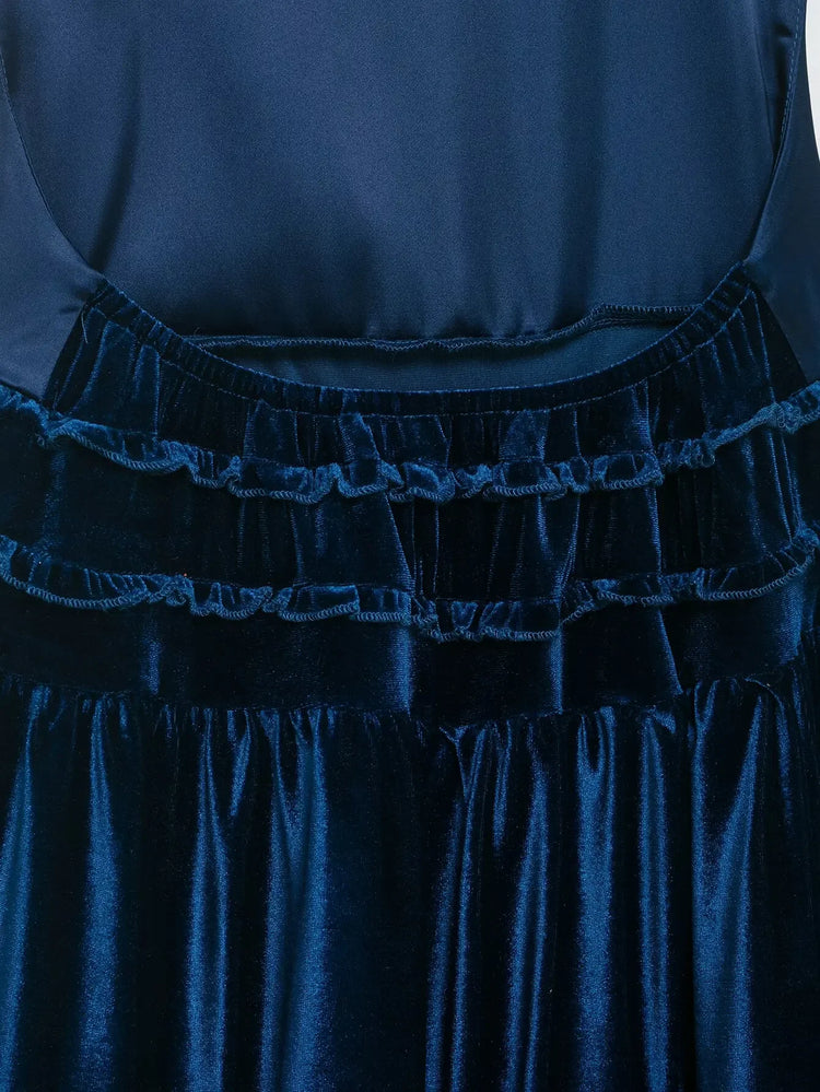 Blue tiered pleated sleeveless women's dress close up on a white background