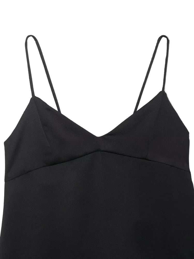 Black top with thin straps on a light gray background