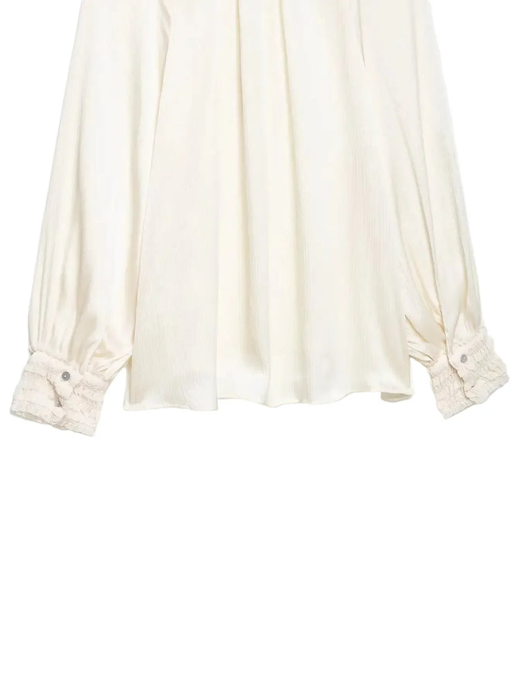 White blouse with rolled-up sleeves on a white background