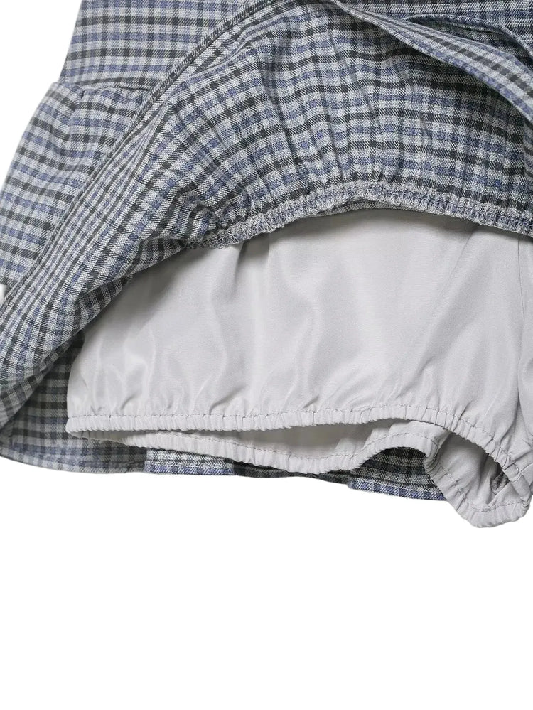 Close-up of a blue and white checkered plaid garment with a white interior lining on a white background
