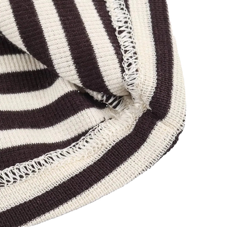 Close-up of a striped fabric with brown and white colors on a light gray background