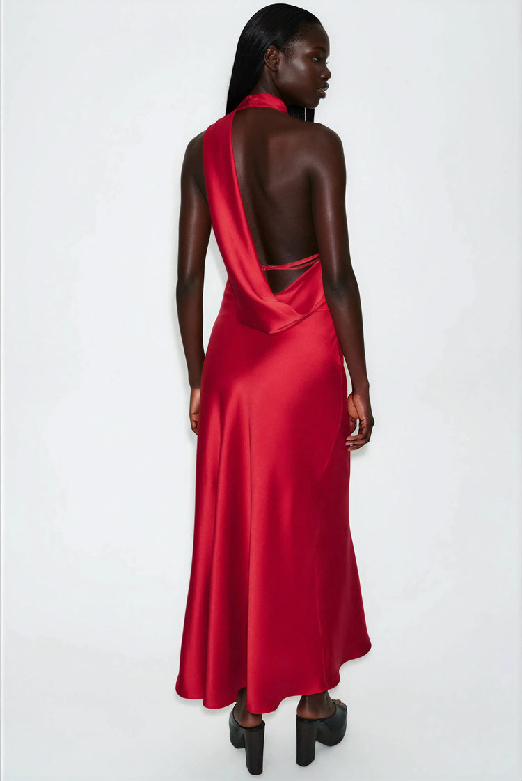Woman wearing a satin red one-shoulder dress on a white background