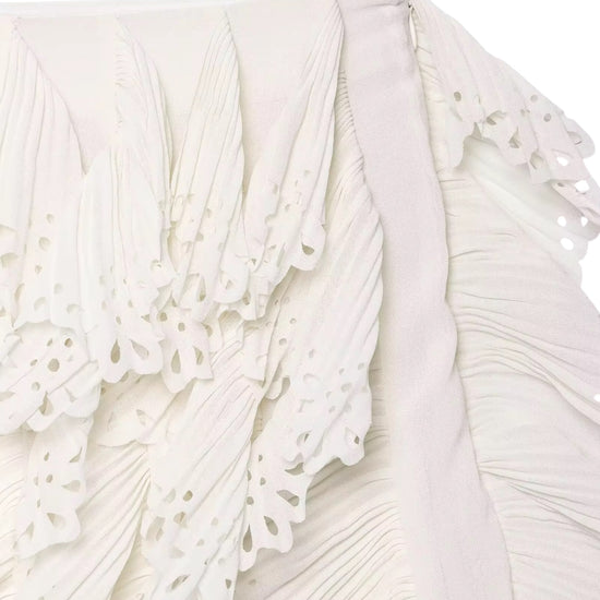 Close-up of a white lace skirt with intricate detailing.