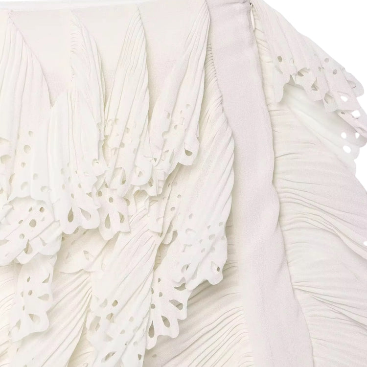 Close-up of a white lace skirt with intricate detailing.