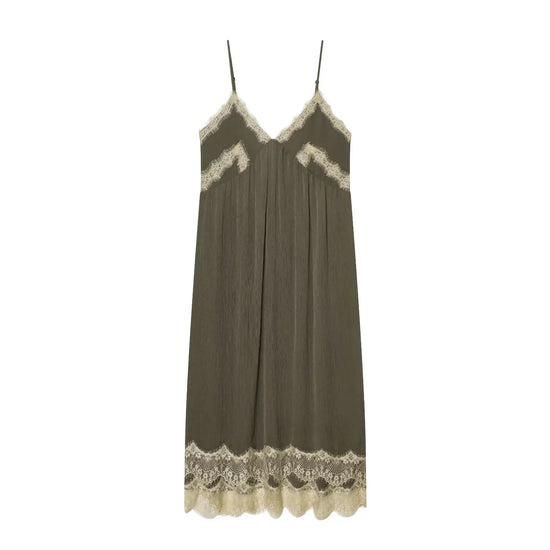 Green slip dress with lace trim on a white background