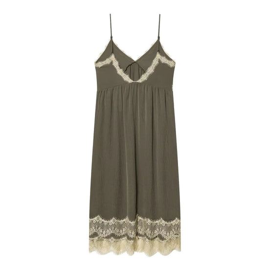 Green slip dress with lace details on a white background