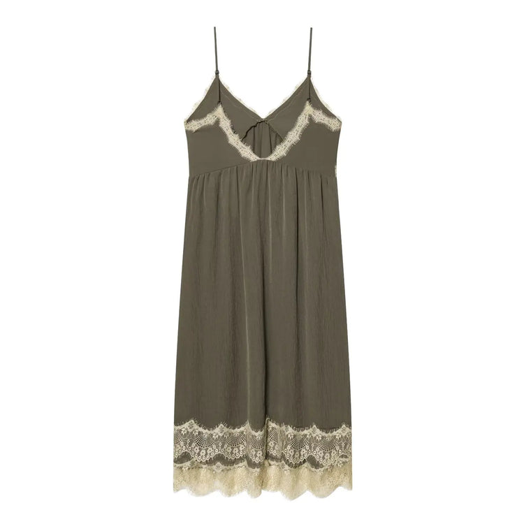 Green slip dress with lace details on a white background
