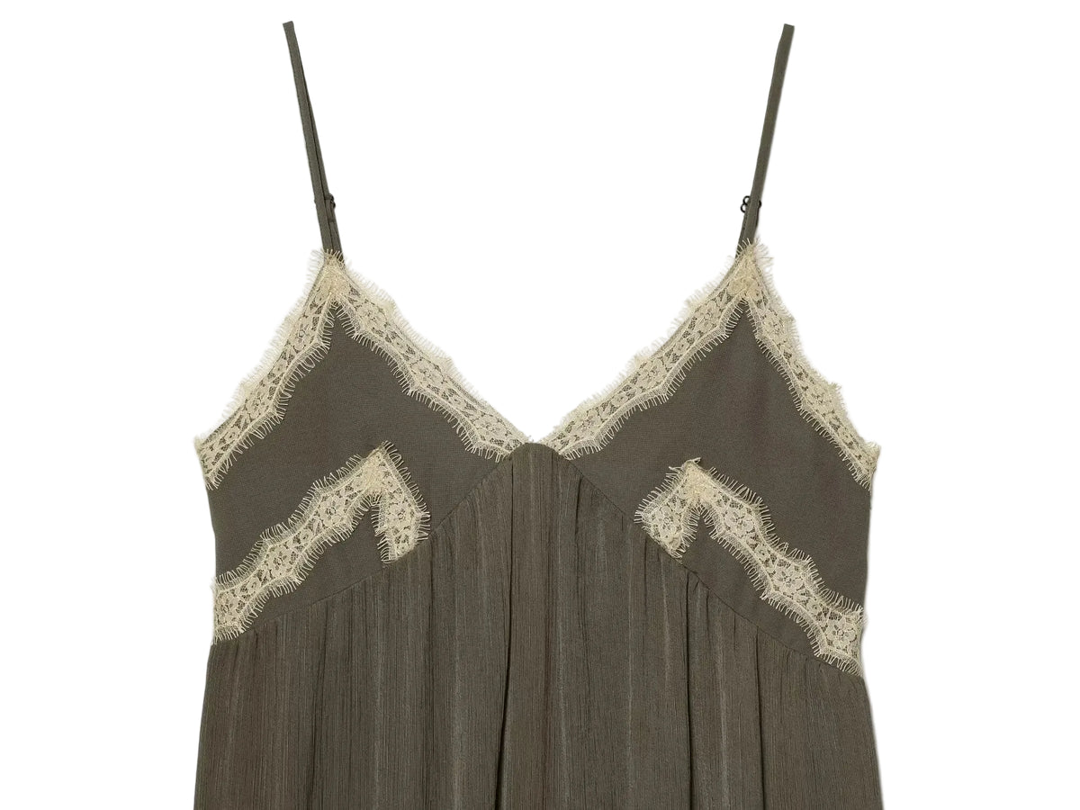 Green slip dress with lace trim on a white background