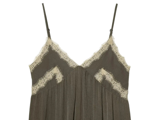 Green slip dress with lace trim on a white background