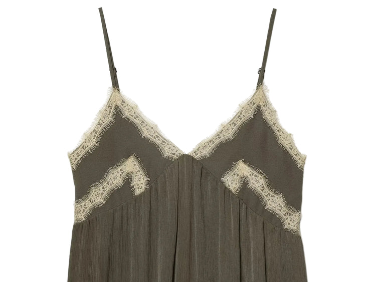 Green slip dress with lace trim on a white background