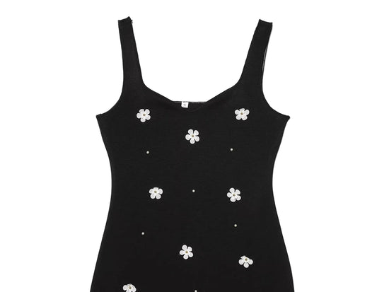 Black women's sleeveless dress with white floral patterns for Spring on a white background close up