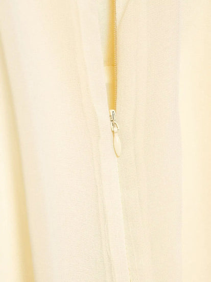 Close-up of a beige zipper on a light background