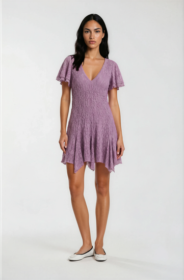 Woman wearing a purple dress on a white background