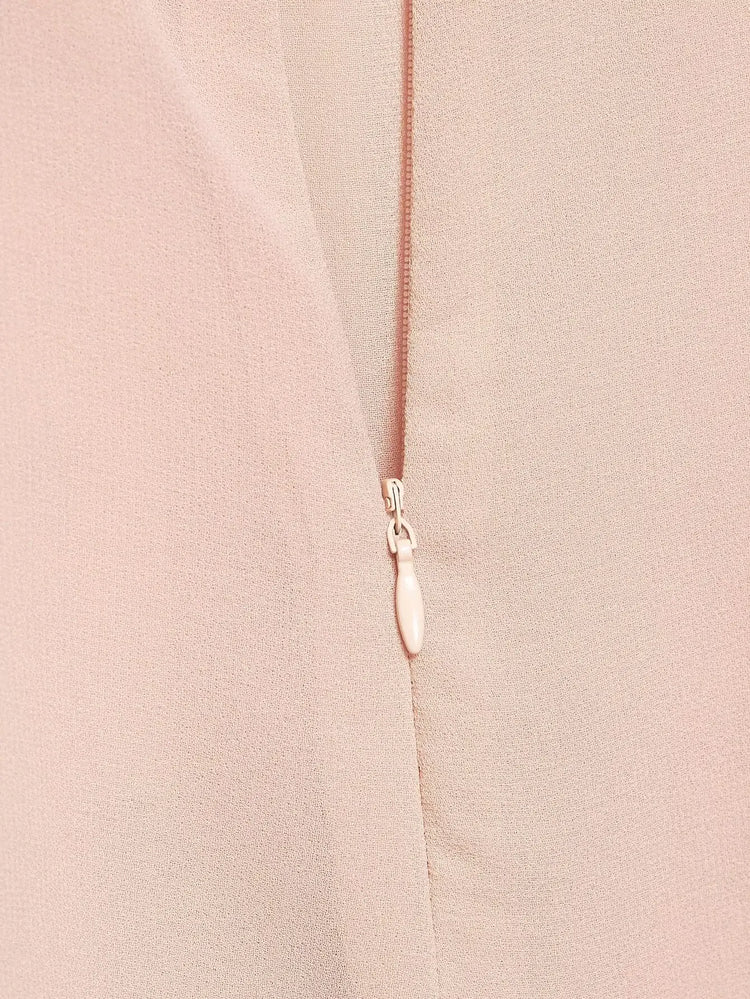 Close-up of a pink zipper on a pink dress