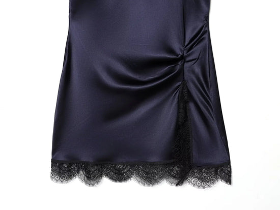 Navy satin dress with black lace trim on a white background