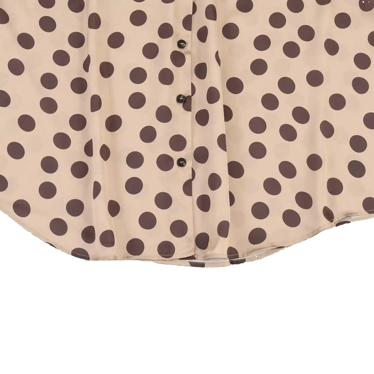Beige shirt with brown polka dot pattern on a light blue background
