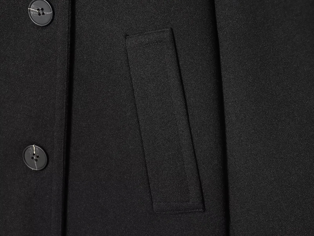 Black women's coat with buttons for Spring on a white background close up of pocket