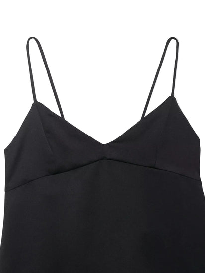 Black top with thin straps on a light gray background