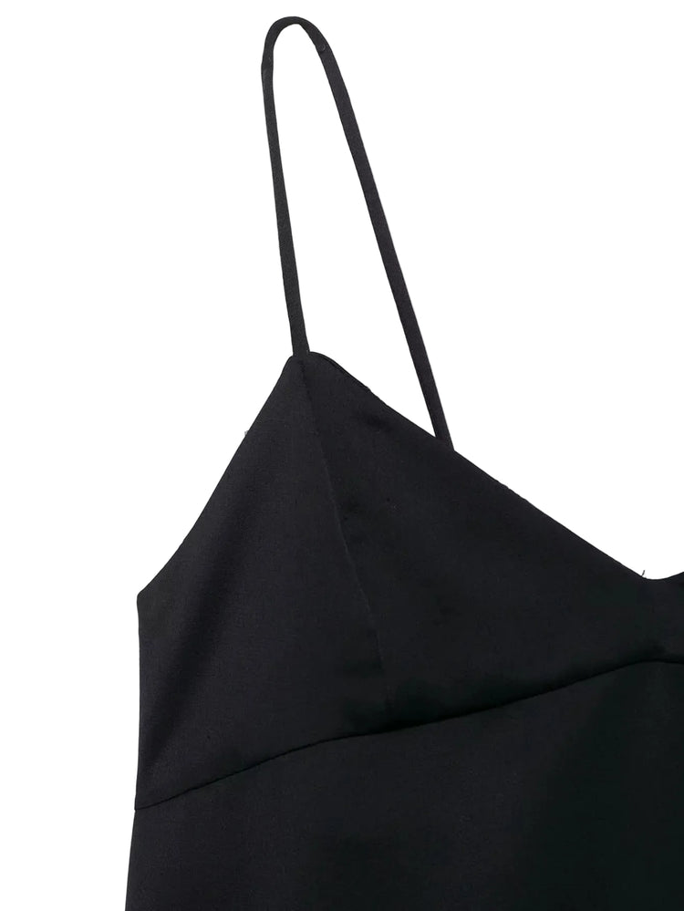 Black top with thin straps on a white background