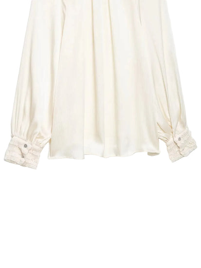 White blouse with rolled-up sleeves on a white background