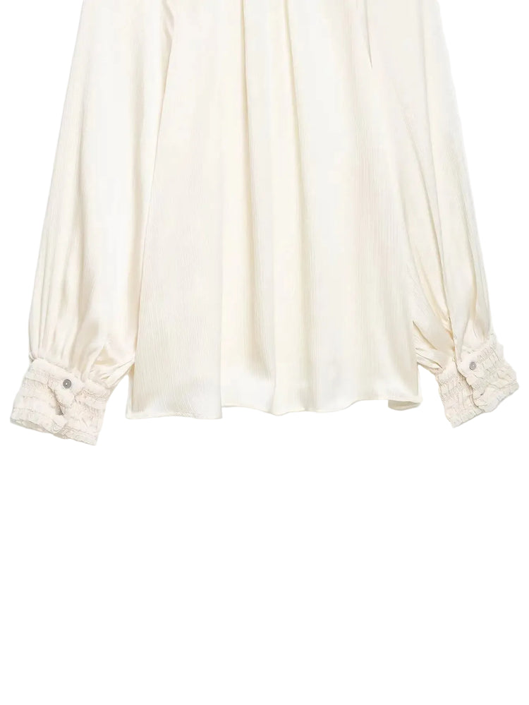 White blouse with rolled-up sleeves on a white background