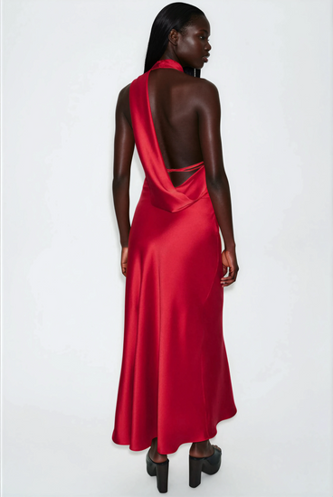 Woman wearing a satin red one-shoulder dress on a white background