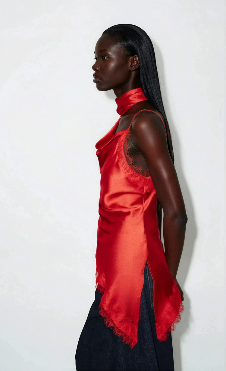 Woman wearing a red top with a white background