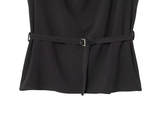 Black sleeveless women's dress top with a belt on a white background close up