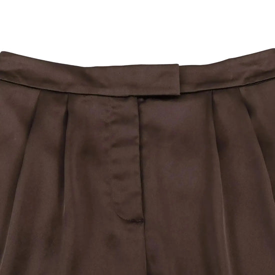 Close-up of a brown pleated shorts on a white background