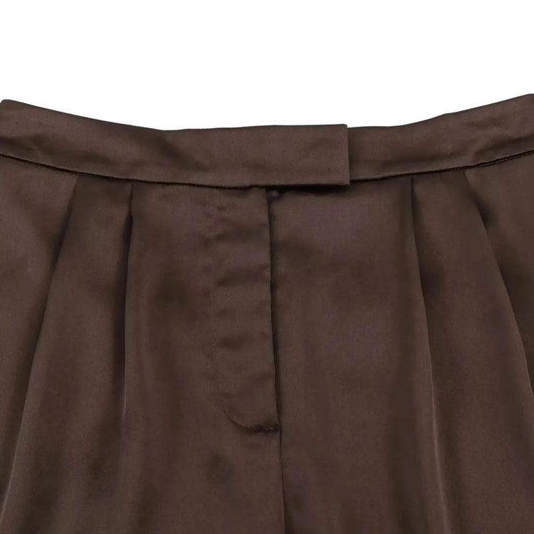Close-up of a brown pleated shorts on a white background