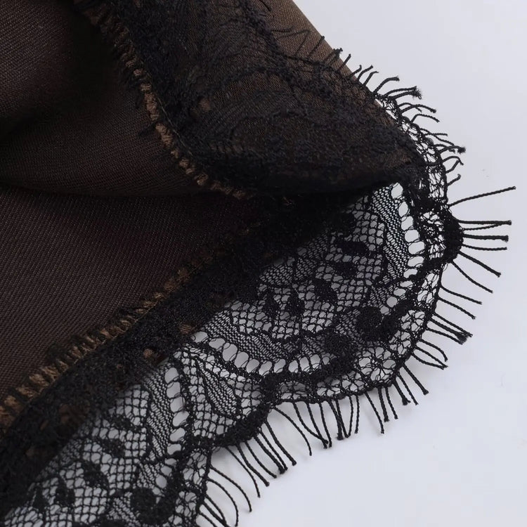 Brown fabric with black lace trim on a white background