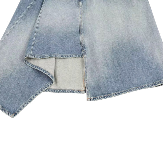 Close-up of a denim women's asymmetrical skirt with a white background